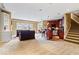 Finished basement with a wet bar, ample seating, and a staircase to the upper level at 14711 Macduff Dr, Noblesville, IN 46062