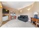 Relaxing basement area features plush carpet, sconce lighting, and leather seating for a comfortable home theater experience at 14711 Macduff Dr, Noblesville, IN 46062