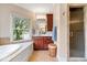 Main bathroom featuring a large oval tub, shower, and vanity with a window offering outdoor views at 14711 Macduff Dr, Noblesville, IN 46062