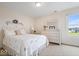 Comfortable bedroom with a queen-size bed, dresser, and a view of the neighborhood at 14711 Macduff Dr, Noblesville, IN 46062