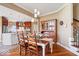 Charming dining room adjacent to the kitchen with hardwood floors, a cozy dining table, and vintage hutch at 14711 Macduff Dr, Noblesville, IN 46062