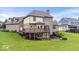 Back exterior of home with brick, deck, and patio at 14711 Macduff Dr, Noblesville, IN 46062