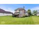 Back exterior of home with brick, deck, and patio at 14711 Macduff Dr, Noblesville, IN 46062