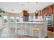 Bright, airy kitchen with granite countertops, stainless steel appliances, and breakfast bar seating provides a stylish gathering space at 14711 Macduff Dr, Noblesville, IN 46062