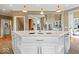Modern open-concept kitchen with white cabinets, ample counter space, and view into the living area provides an inviting atmosphere at 14711 Macduff Dr, Noblesville, IN 46062