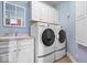 Laundry room with washer, dryer, utility sink, and built in cabinets at 14711 Macduff Dr, Noblesville, IN 46062