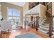 Inviting living room showcasing hardwood floors, staircase, and a dining area in the background at 14711 Macduff Dr, Noblesville, IN 46062