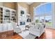 Bright living room featuring built-in bookshelves, a fireplace, and large windows at 14711 Macduff Dr, Noblesville, IN 46062
