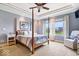 Serene main bedroom with four-poster bed, tray ceiling, and abundant natural light at 14711 Macduff Dr, Noblesville, IN 46062
