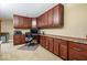 Office with extensive built-in cherry-wood cabinets and drawers for ample storage at 14711 Macduff Dr, Noblesville, IN 46062