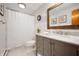 Bathroom with white shiplap walls, a gray vanity, and a shower with a white curtain at 1495 E 240 N, Anderson, IN 46012