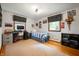 Bedroom with hardwood floors, a striped bedspread, a desk, and colorful wall decor at 1495 E 240 N, Anderson, IN 46012