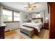 This bedroom boasts hardwood floors, light gray walls, and bright windows for a cozy and inviting atmosphere at 1495 E 240 N, Anderson, IN 46012