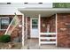Inviting front porch with 'Welcome' sign, decorative plants, and charming decor details at 1495 E 240 N, Anderson, IN 46012