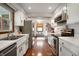 Spacious kitchen featuring white cabinets, stainless steel appliances, and hardwood flooring at 1495 E 240 N, Anderson, IN 46012