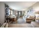 Bright living room featuring neutral walls, comfortable seating, stylish decor, and natural light at 1495 E 240 N, Anderson, IN 46012