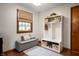 Mudroom featuring a white storage unit with baskets and a gray bench with a patterned rug at 1495 E 240 N, Anderson, IN 46012