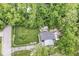 Aerial view of home featuring a large lawn and deck surrounded by mature trees at 1513 Alimingo Dr, Indianapolis, IN 46260