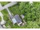 Aerial view of backyard featuring a nice sized deck and mature trees surrounding property at 1513 Alimingo Dr, Indianapolis, IN 46260