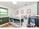 A bunk bed sits in a charming room with wood flooring, green chair rail and white upper walls at 1513 Alimingo Dr, Indianapolis, IN 46260
