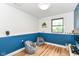 Cozy room with wood laminate flooring, blue chair rail and two beanbag chairs at 1513 Alimingo Dr, Indianapolis, IN 46260