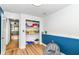 Room with wood laminate flooring, walk in closet, a blue chair rail and white upper walls at 1513 Alimingo Dr, Indianapolis, IN 46260