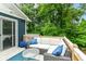 Relaxing deck with blue accents, a sectional sofa, and a view of lush greenery at 1513 Alimingo Dr, Indianapolis, IN 46260