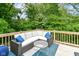 Inviting deck featuring a comfortable sectional sofa and serene wooded views at 1513 Alimingo Dr, Indianapolis, IN 46260