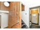 A stairway entryway featuring modern wood slat railing with gray steps and white walls in a naturally lit space at 1513 Alimingo Dr, Indianapolis, IN 46260