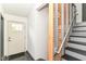 A clean entryway featuring tile floors, stairs with wooden accents, and a front door with glass panels at 1513 Alimingo Dr, Indianapolis, IN 46260