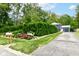 Front exterior features colorful flowerbeds in front of a two-story home with a garage at 1513 Alimingo Dr, Indianapolis, IN 46260