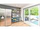 Bright kitchen with deck access, stainless steel refrigerator, and open shelving at 1513 Alimingo Dr, Indianapolis, IN 46260