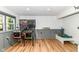 This finished basement boasts two pinball machines, laminate floors and gray chair rail paneling at 1513 Alimingo Dr, Indianapolis, IN 46260