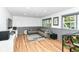 This finished basement features a gray sectional sofa, recessed lighting, and a Jurassic Park pinball machine at 1513 Alimingo Dr, Indianapolis, IN 46260