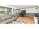 This finished basement has recessed lighting, wood flooring, gray chair railing and two pinball machines at 1513 Alimingo Dr, Indianapolis, IN 46260