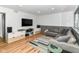Finished basement area includes laminate floors, gray chair rail, a sectional and built-in shelving unit at 1513 Alimingo Dr, Indianapolis, IN 46260