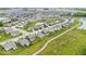 A picturesque aerial view of a well-planned community with a pond, walking paths, and uniformly designed homes at 1539 Hazy Falls Blvd, Westfield, IN 46074