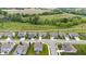 An aerial view of a quiet residential neighborhood surrounded by green spaces and fields, offering a serene living environment at 1539 Hazy Falls Blvd, Westfield, IN 46074