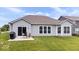 This is a well-maintained backyard featuring a small patio and a neatly manicured lawn at 1539 Hazy Falls Blvd, Westfield, IN 46074