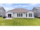 Well-maintained backyard featuring a small patio and a neatly manicured lawn perfect for outdoor enjoyment at 1539 Hazy Falls Blvd, Westfield, IN 46074