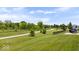 Backyard featuring a large manicured yard, walking path, and an outdoor seating area with beautiful views at 1539 Hazy Falls Blvd, Westfield, IN 46074