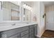 Bathroom featuring double vanity with modern gray cabinets and large mirrors at 1539 Hazy Falls Blvd, Westfield, IN 46074