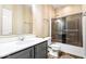 Stylish bathroom with a modern vanity, sleek fixtures, and a glass-enclosed shower/tub combination at 1539 Hazy Falls Blvd, Westfield, IN 46074