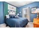 Cozy bedroom with blue walls and a comfortable-looking bed with decorative quilt and matching cushions at 1539 Hazy Falls Blvd, Westfield, IN 46074