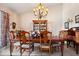 Formal dining room featuring a wooden table, ornate chandelier, and decorative cabinet with glass doors at 1539 Hazy Falls Blvd, Westfield, IN 46074