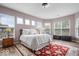 Bright main bedroom with large windows, red rug, neutral walls, and a cozy sitting area at 1539 Hazy Falls Blvd, Westfield, IN 46074