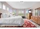 Bright main bedroom with windows, a large bed, and dresser with television at 1539 Hazy Falls Blvd, Westfield, IN 46074