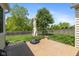 A brick patio with an umbrella in a backyard with a wood fence and landscaping at 16126 Hymera Green, Westfield, IN 46074