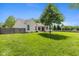 Lush green backyard featuring privacy fence, large shade tree, and siding exterior at 16126 Hymera Green, Westfield, IN 46074