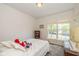 Comfortable bedroom featuring a cozy bed, a large window, a dresser, and a vintage lamp at 16126 Hymera Green, Westfield, IN 46074